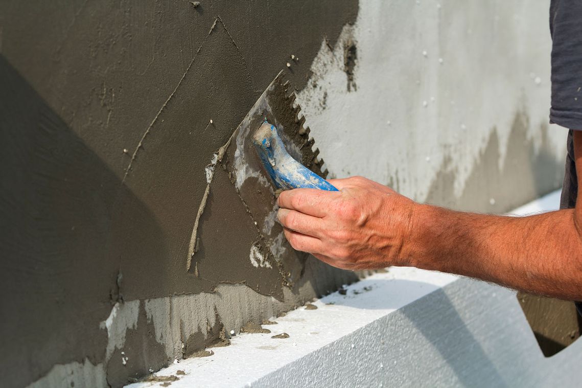 plasterer applying plaster to a wall